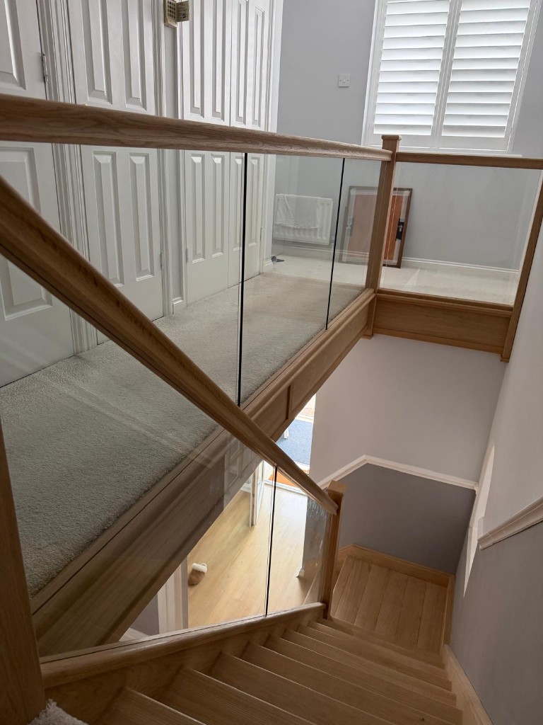 Top view of a custom solid oak staircase with glass balustrading in Strood, Kent